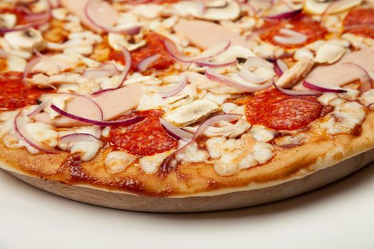Delicious pizza BBQ sauce, mozzarella cheese, ham, pepperoni, smoked chicken, mushrooms, red onion. Close-up. Restaurant flyer and poster.