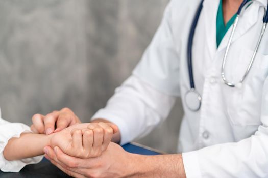 Young doctor examining female patient in hospital office. Medical healthcare and doctor staff service concept.