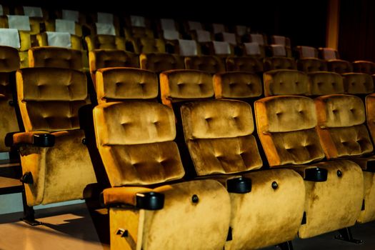 A row of yellow seat with popcorn on chair in the movie theater