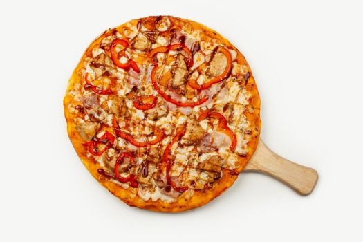 Delicious pizza with bacon and chicken Teriyaki served on a wooden plate, ingredients Signature sauce, mozzarella cheese, Teriyaki chicken, bacon, Bulgarian pepper, Teriyaki sauce on white