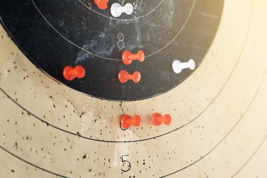 The target is marked with pins. Colored pins indicate on the target in the dash the shooters hit from the weapon