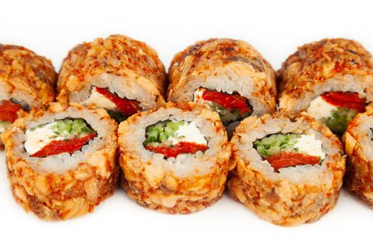 Sushi Roll with fried salmon in Teriyaki sauce on a white plate, ingredients Fried salmon, cream cheese, cucumber, baked pepper, flying fish roe, Spicy sauce, rice, nori. For the restaurant menu