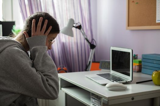 A school girl found unbelievable news about her peers on the internet. A young girl with pigtails.