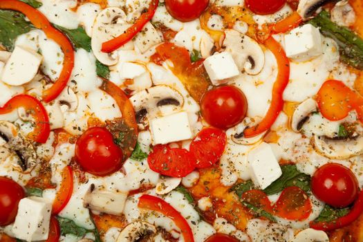 Delicious Vegetarian pizza served on a wooden plate, the ingredients are signature sauce, basil, mozzarella cheese, champignons, bell peppers, cherry tomatoes, feta cheese. Pizzeria promotion poster.