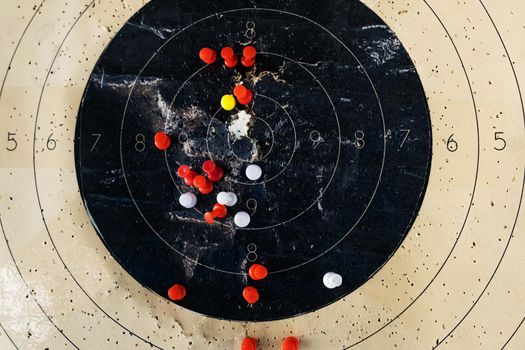 The target is marked with pins. Colored pins indicate on the target in the dash the shooters hit from the weapon