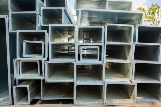 Ventilation pipes are square and rectangular. Steel pipes, parts for the construction of air ducts for an industrial air conditioning system in a warehouse. Industrial ventilation equipment