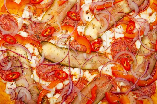 Texture of a delicious pizza Spicy pepper served on a wooden plate, ingredients Signature sauce, mozzarella cheese, pepperoni, pickled cucumber, bell pepper, red onion, chili pepper.