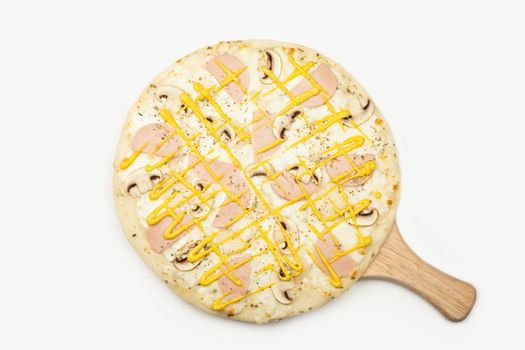 Delicious pizza Ham mushrooms served on a wooden plate, ingredients Signature sauce, mozzarella cheese, ham, mushrooms, mustard sauce on white. Pizzeria promotion poster.