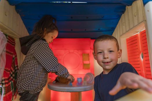 Children play in the children's house with toys