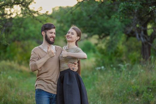 couple shows a gesture that everything is fine being in nature