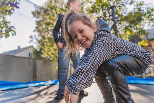 children have fun jumping on a trampoline, bottom view