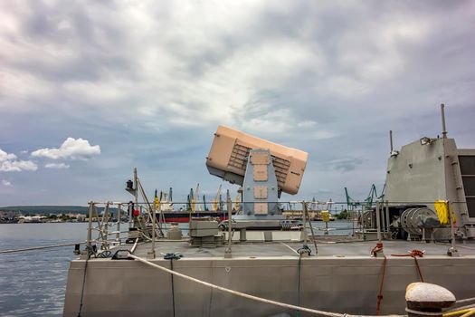 The cassette missile system onboard a frigate.A dangerous weapon. The battery of guns for the defense of military ships.