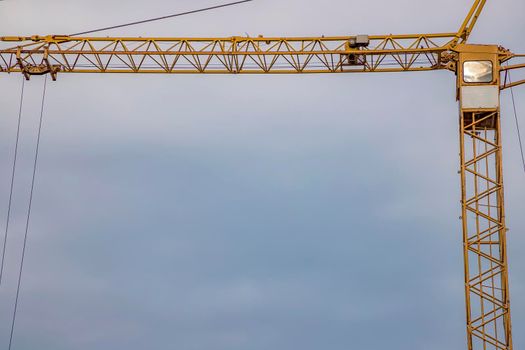 Construction crane tower on blue sky background. Empty Space for text. Construction concept. 