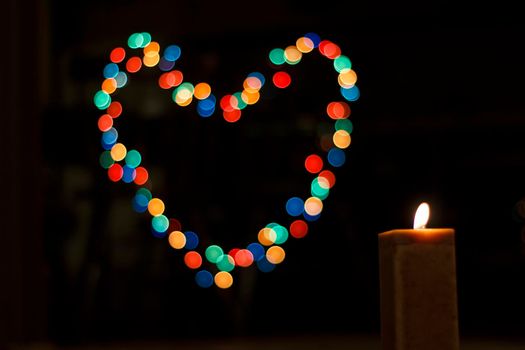 Candles light with background bokeh like a heart. Abstract candle background. Horizontal view.