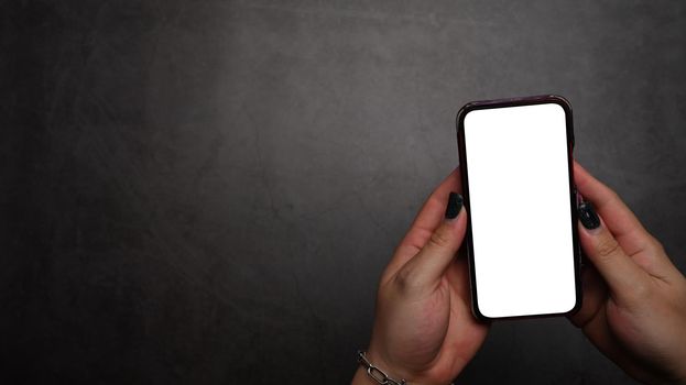 Hands holding mockup smartphone and empty screen.