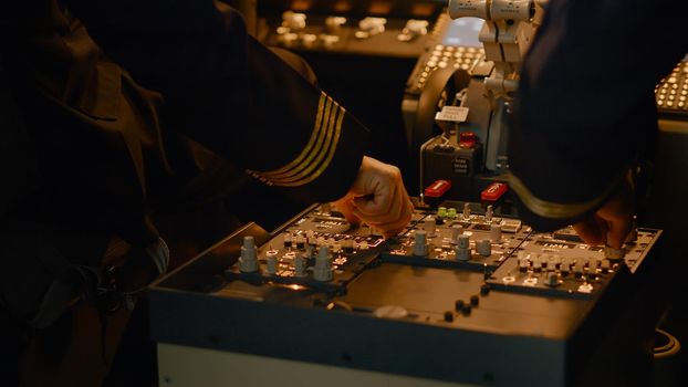 Plane aircrew preparing for aviation flight with dashboard command, using navigation compass and windscreen to fly airplane. Aerial transportation with control panel buttons. Close up.