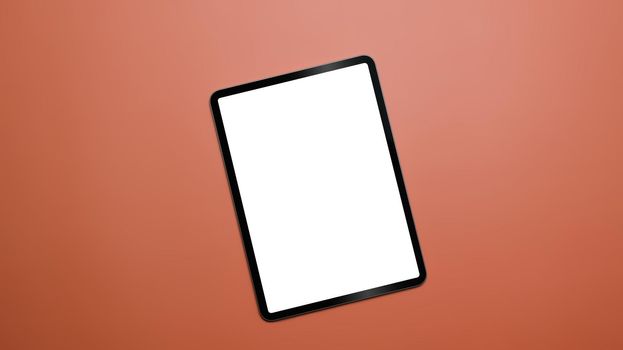 Digital tablet with empty screen on orange background with copy space. Top view, Flat lay.