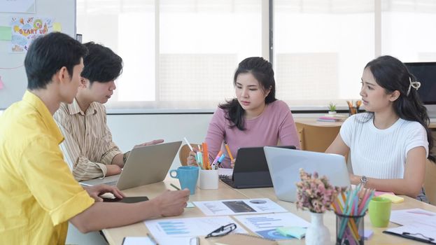 Startup business people brainstorming and planning start up project together in modern office.