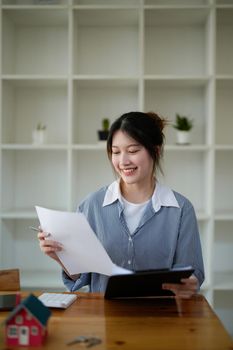 Portrait real estate agent working with financial loan and contract agreement on workplace.