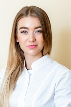 Vertical portrait of beautiful young woman wearing white shirt on yellow background.