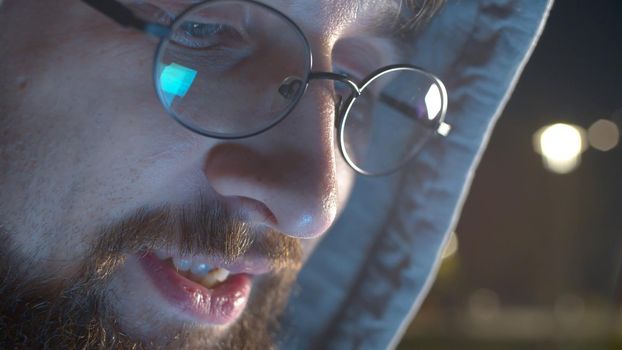 Close up portrait of a smiling handsome young man outdoors