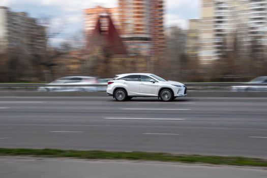 Ukraine, Kyiv - 6 April 2021: White Lexus RX car moving on the street. Editorial