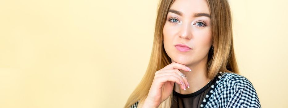 Portrait of a casual business woman sitting at her workplace in home office.