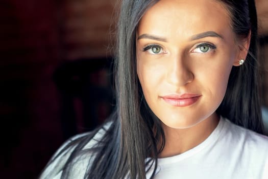 Portrait of beautiful young woman looking at camera. Portrait of brunette business woman.