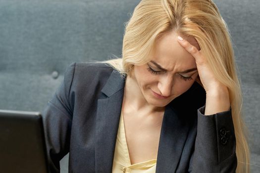 Woman looking surprised while using smartphone at the workplace at home.