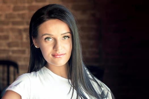 Portrait of beautiful young woman looking at camera. Portrait of brunette business woman.