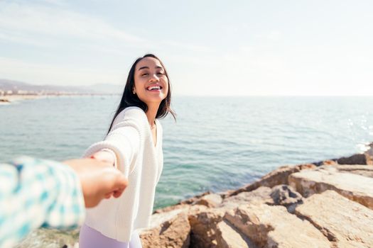 smiling young asian woman holding hand of her love couple, concept of love and romanticism