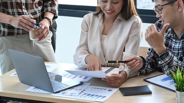 Young businesswoman sharing ideas or startup business plan with business partner.