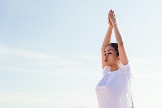 portrait of a young asian woman meditating practicing yoga with her eyes closed, concept of spirituality and relax