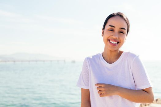 portrait of a smiling young asian woman dressed in white, concept of happiness and purity