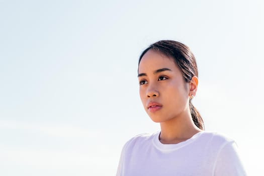 portrait of a serious young asian woman in white