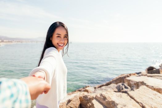 happy young asian woman holds hands with her love partner, concept of love and romanticism