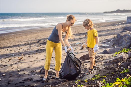 Mother and son are cleaning up the beach. Natural education of children.