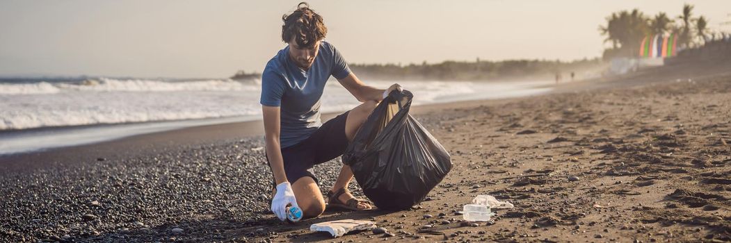 Young man cleaning up the beach. Natural education of children. BANNER, LONG FORMAT