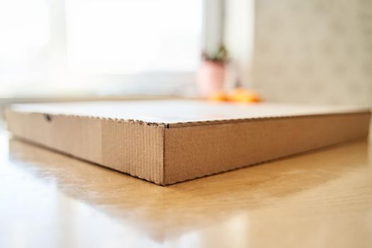 Blank brown cardboard Pizza paper box on the table. Packaging template mockup collection. Stand-up Front view package.