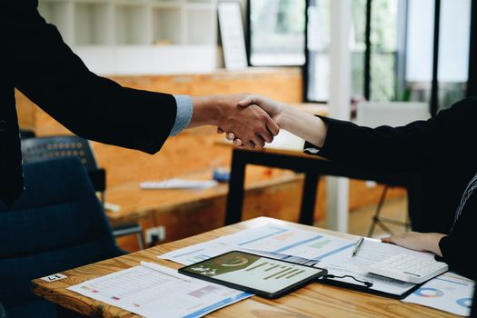 Two business people shake hands after accepting a business proposal together, a handshake is a universal homage, often used in greeting or congratulations