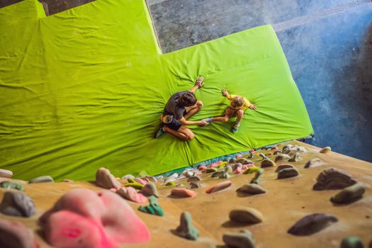 Dad and son at the climbing wall. Family sport, healthy lifestyle, happy family.