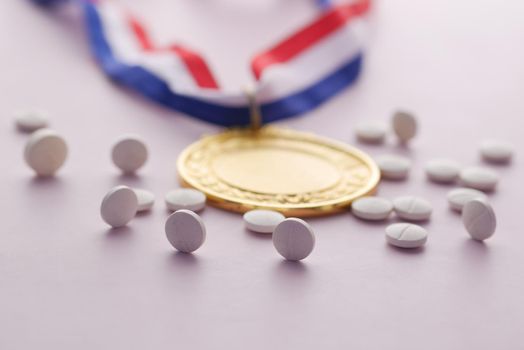 First Place Throphy and medical pills on white background .
