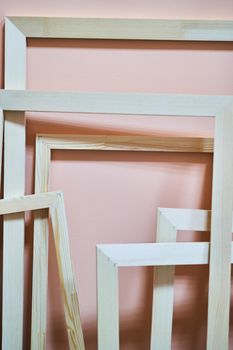 Wooden frames on a pink background. Abstraction. Frames for photos and paintings. Decoration