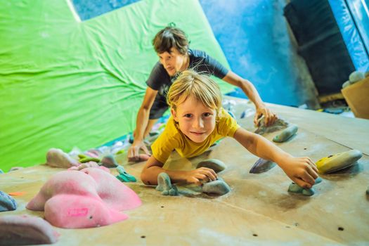 Dad and son at the climbing wall. Family sport, healthy lifestyle, happy family.