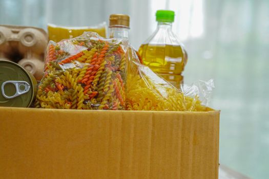 Foodstuffs in donation box for volunteer.