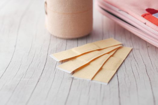 adhesive bandage and a bag on table ,