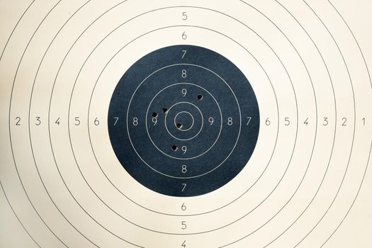 Target with numbers for shooting at a shooting range. A round target with a marked bull's-eye for shooting practice on the shooting range. Target with bullet holes