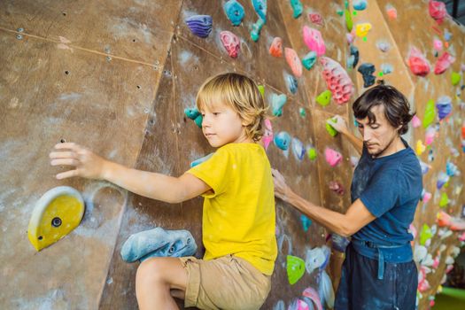 Dad and son at the climbing wall. Family sport, healthy lifestyle, happy family.