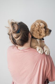 Young woman hugs her dog. The dog lies on the shoulder at a young woman. High quality photo