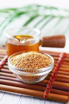 coking oil and seeds in a container on table .